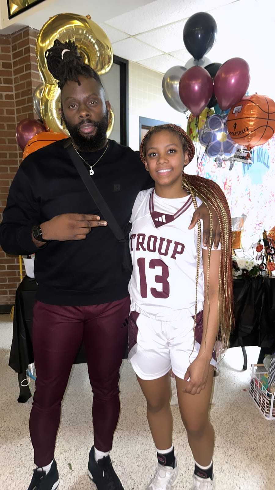 Coach Black celebrating with a high school player