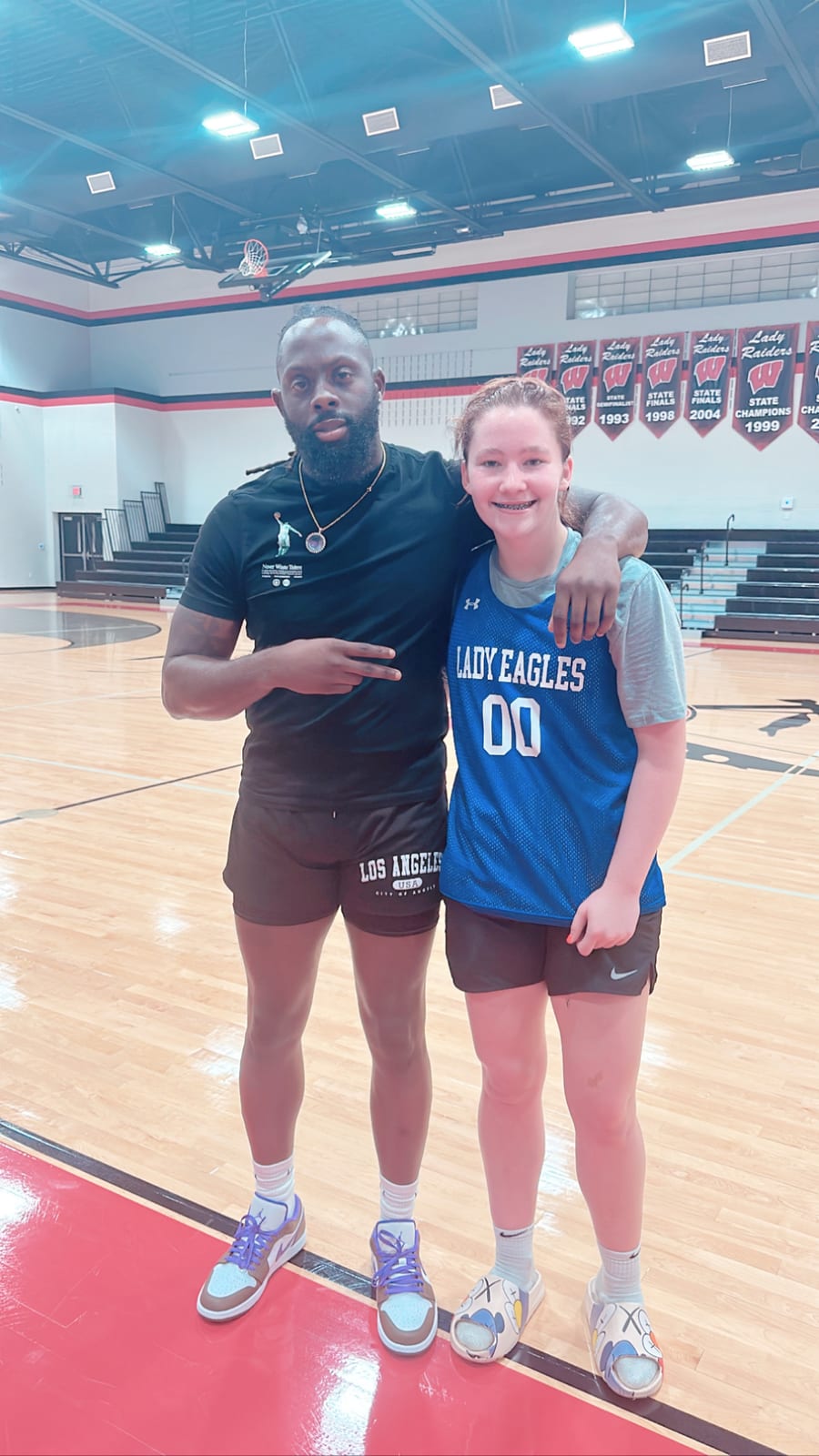 Coach Black with a Dog Pound player at the gym
