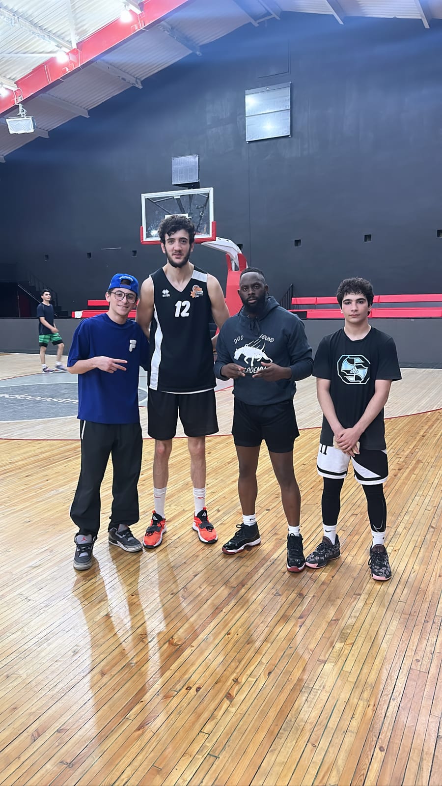 Coach Black with a training group on the court